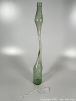 Full elongated stretched Coca-Cola bottle with clear view of overall shape and size