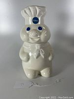 Front view photo of the vintage Pillsbury Doughboy cookie jar showing face and chef hat with Pillsbury logo.