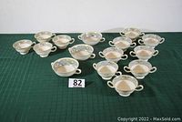 All 15 bone china pieces arranged showing 4 teacups, 8 double-handle teacups/bouillon cups, and 3 larger double-handle cups.