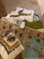 Assorted folded linens including placemats and towels with tags visible