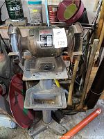 Full view of bench grinder on pedestal with side trays
