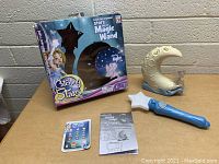 Photo of full set: Catching Stars Magic Wand, crescent moon star projector, star cards, instruction sheet, original box.