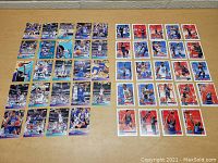 Overhead view of 36 basketball trading cards laid out, 1992 All-Star on left with purple/teal borders and 1993 All-Star on right with red/white borders.