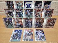 Front view of 18 Dallas Cowboys NFL Pro Set football cards arranged in 3 rows, all in protective sleeves.