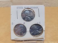 Front view of the 3 steel war pennies in a holder showing all coins and labeled mint marks D, P, and S.