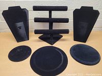 Photo showing the two necklace bust displays, triple horizontal T-bar bracelet holder, single slanted T-bar holder, and three velvet trays laid out on a table.