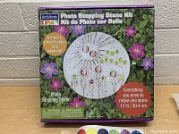 Boxed ArtMinds Photo Stepping Stone Kit with flower-themed packaging showing photo holders and stickers included.