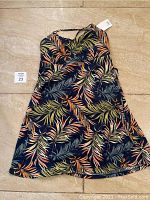 Full view of medium SO summer dress laid flat showing entire length and pattern.