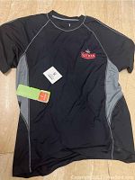 Front side view of black and gray T-shirt with Sleeven logo and tags attached