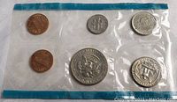 Full view of all six 1971 American coins sealed in original plastic packaging, including penny, nickel, dime, quarter, half dollar, and dollar coin.