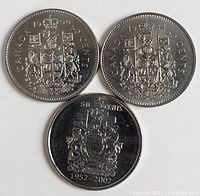 Obverse side showing Canadian Coat of Arms on three coins dated 1990, 1984, and 1952-2002 commemorative edition