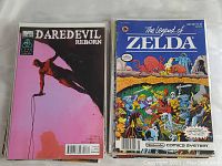 Comic books displayed with Daredevil Reborn (Marvel) and The Legend of Zelda (Valiant) covers visible.