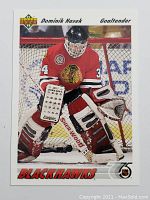 Front of Dominik Hasek rookie hockey card showing player in goalie gear with Chicago Blackhawks red jersey number 34.