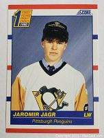 Front view of 1990 Score Jaromir Jagr rookie card showing the player in Pittsburgh Penguins jersey with draft emblem and card branding.