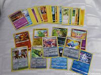 Front layout of assorted Pokémon cards including foil cards laid out showing artwork and card details.