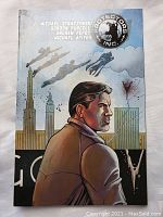 Front cover of Protectors Inc graphic novel showing illustrated man and cityscape with superheroes above.