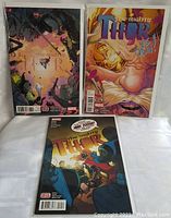 Group photo of three The Mighty Thor comic books, showing all covers.