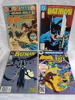 Four vintage Batman-related comic books displayed together, showing all covers clearly.