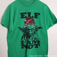 Front view of green short-sleeve t-shirt with black and red graphic of Yoda wearing a Santa hat and text 'ELF I AM NOT'.