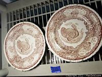 Two Staffordshire porcelain plates featuring turkey patterns viewed from top showing full pattern and decoration.