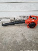Full side view of the orange and black ECHO PB-250LN gas leaf blower showing the blower tube, handle, and intake fan.