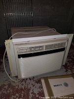 Full view of Kenmore large window air conditioner with white plastic casing, air vents, and attached power cord.