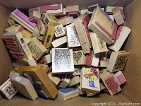Full box filled with various wooden craft rubber stamps showing a variety of designs in the lot.