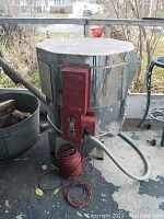 Exterior view of stainless steel kiln body with red control module