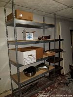 Steel shelving unit in a basement or storage room, showing four wood shelves held in a steel frame. Items on shelves not included.