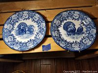 Two large Villeroy & Boch porcelain plates side-by-side on wooden surface, showing blue turkey and floral pattern on white background.