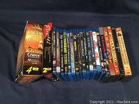 Photo showing the full collection of DVDs and Blu-Ray discs arranged standing against a dark background.
