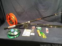 Overview of two rods with mounted reel, line spools, lures, scissors, book