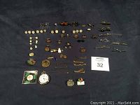 Full view of all vintage and new gentlemen's accessories including cufflinks, shirt studs, tie clips, pins, pocket watch, and collectible coins.
