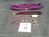 Full lot overview showing hairband, necklace, earrings, pill case, and rhinestones.