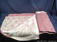 Photo showing the reversible fabric with white side with pink embossed rings and pink reverse side.