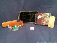 Photo of the poker, cribbage and dice set leather case with cards, fabric wall hanging and card describing the wall hanging