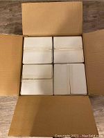 Four individual boxes neatly packed inside a larger shipping box containing the four light fixtures or lamps, unopened and new.