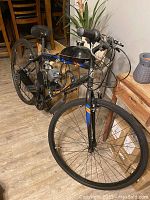 Front ¾ view of bike showing handlebar, front wheel and mounted fuel tank