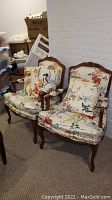 Pair of chairs seen front-on showing overall shape and upholstery pattern