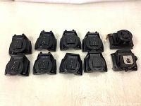 Ten Canon Speedlite flash hot shoe mount bases arranged in two rows showing front with contact points and mounting foot.