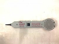 Top view of the 200EP Inductive Amplifier showing the probe end and speaker grille with printed text including model number and manufacturer.