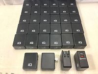 Array of 34 black USB wall chargers with iQ branding, all showing folded plug sides.