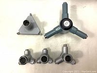 Photo of five Mitutoyo Digimatic Holtest measuring head parts laid out on a flat surface, showing various angles and details.