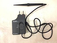 Fluke 80T-150U temperature probe laid out showing probe tip, cable and connectors