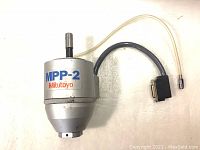 Top view of digital scanning probe labeled MPP-2 Mitutoyo with cable attached.