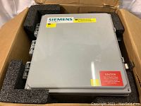 Gray Siemens ServiceBox Valerio industrial control panel enclosure in cardboard box with foam packaging.