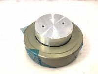 Metal air bearing pad viewed from side showing round profile and aluminum top with protective tape on edges.