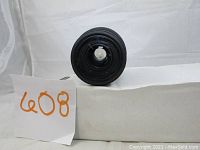 Front view of lens showing aperture blades and front glass element with dust spots.