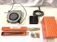 Photo showing Howard DC blower fan, black foot switch with cable, Mitutoyo tool box and several packaged tool accessories.