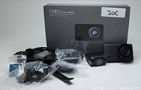 Photo of Apeman C860 dash camera box, front and rear cameras, mounting hardware, cables and accessories neatly arranged.